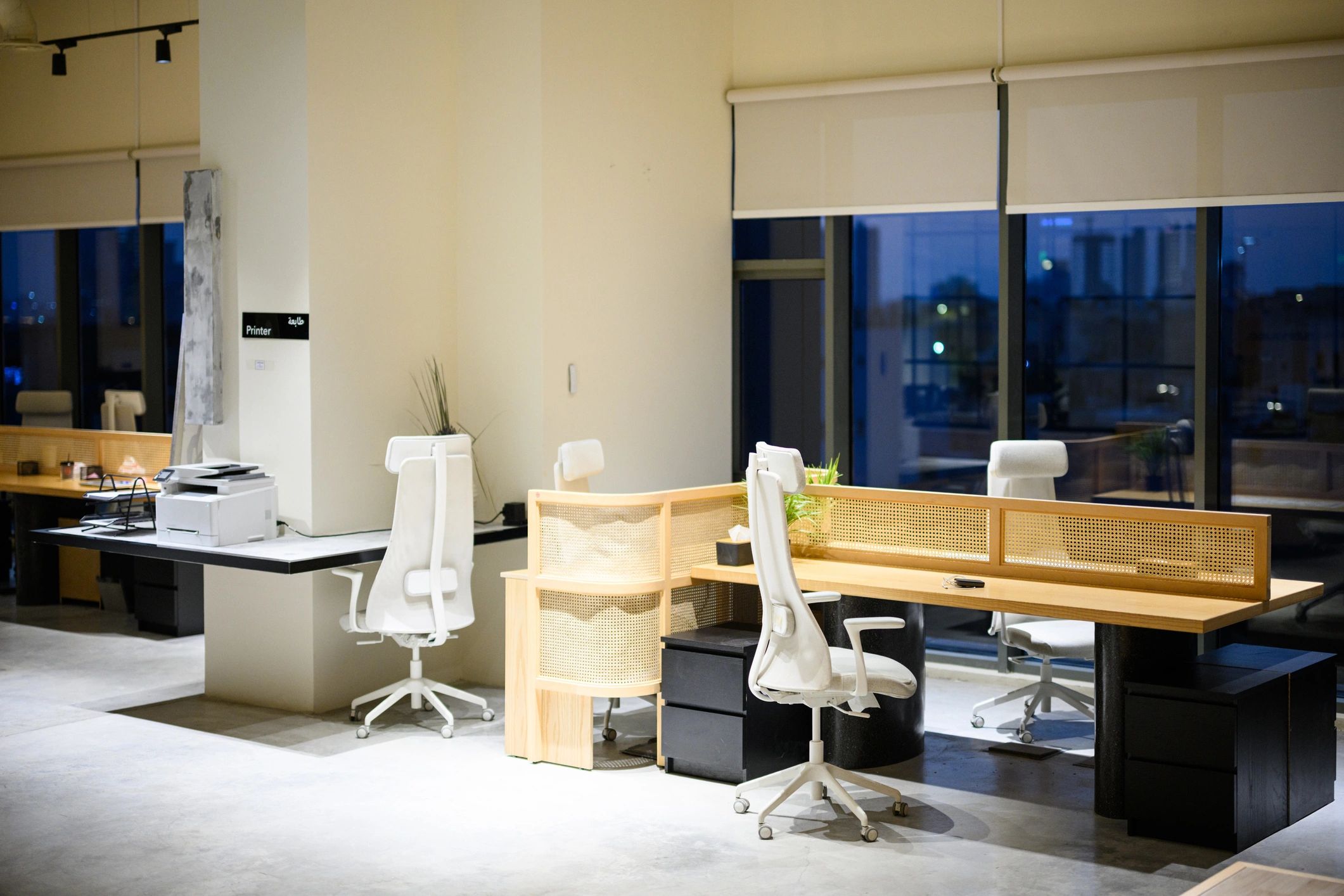 Modern commercial office interior with shared desks and polished finishes