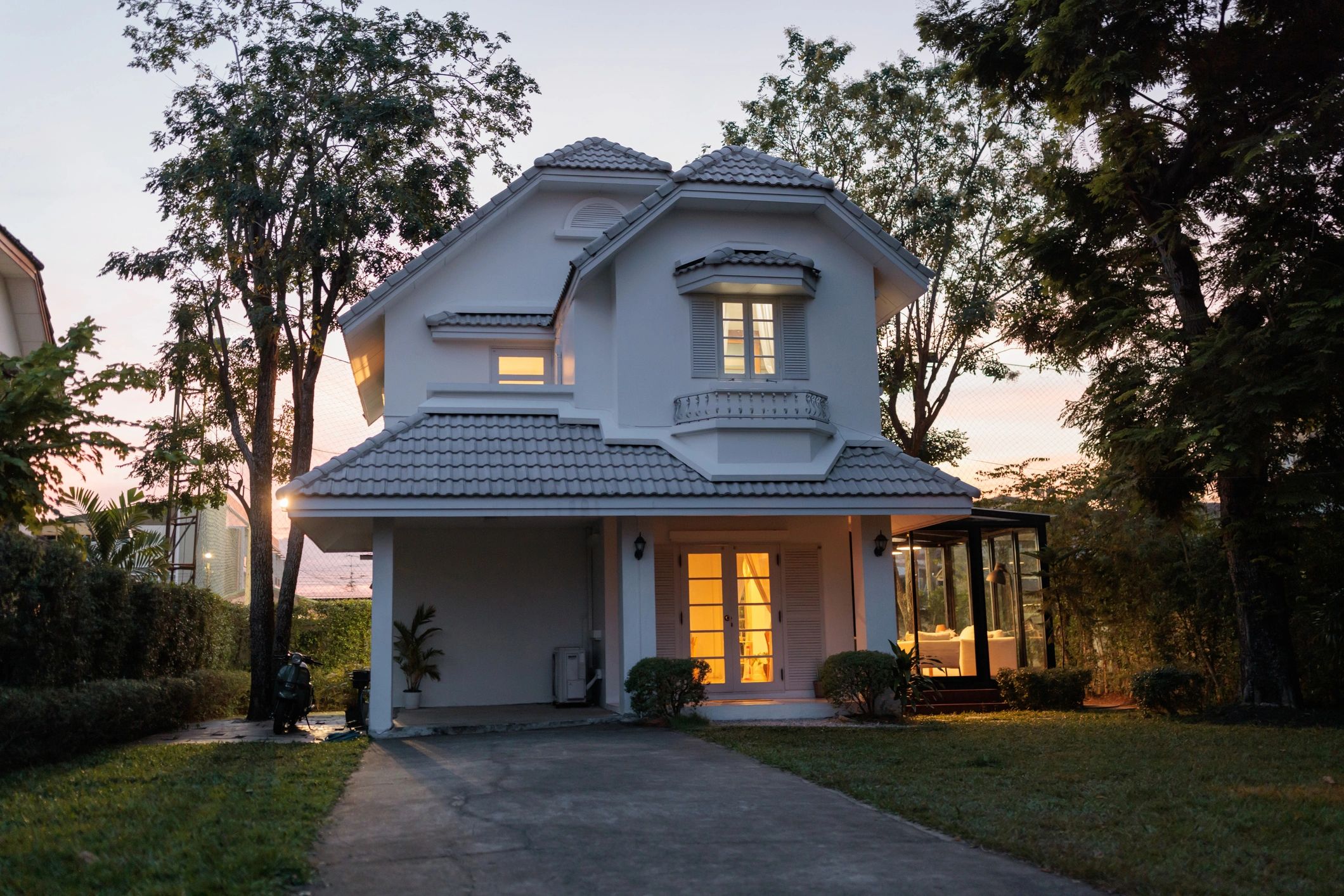 Custom home exterior at dusk showing architectural detail and curb appeal